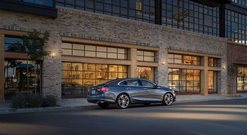 A grey 2021 Chevy Malibu is shown from the side.