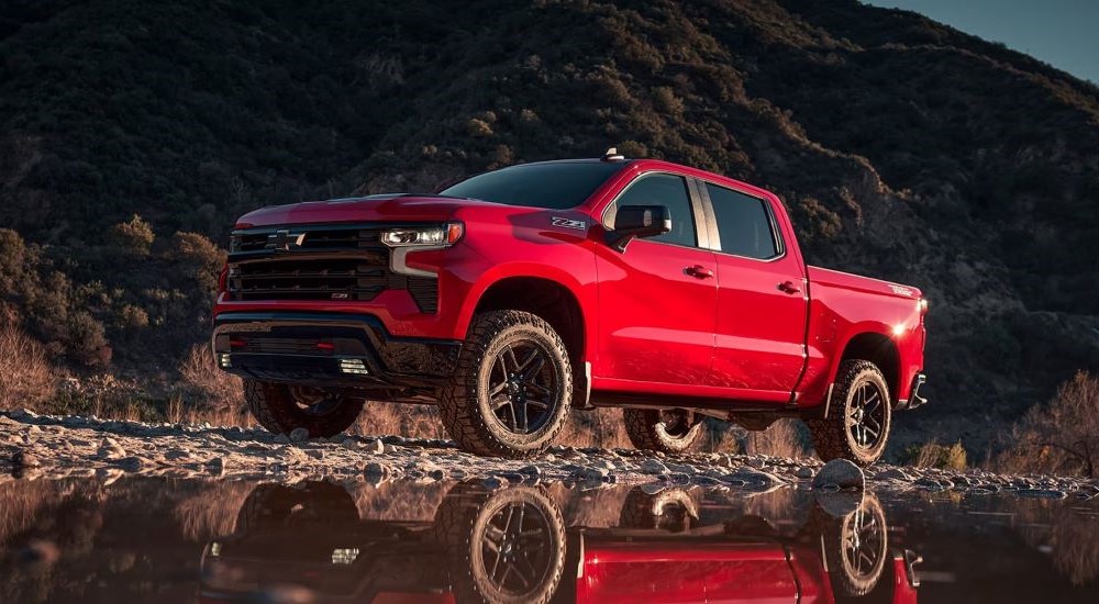 A red 2023 Chevy Silverado 1500 Z71 Trail Boss is shown from the side.