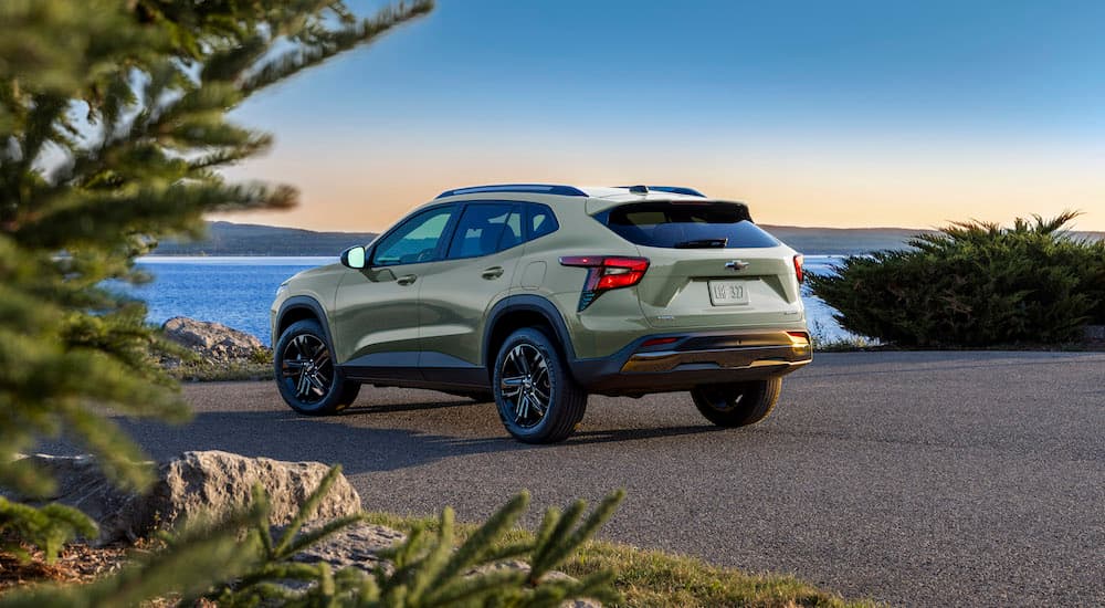 A green 2025 Chevy Trax near a coast.