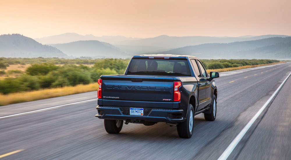 A blue 2025 Chevy Silverado 1500 RST from behind after leaving a Chevy dealer near Eagan.
