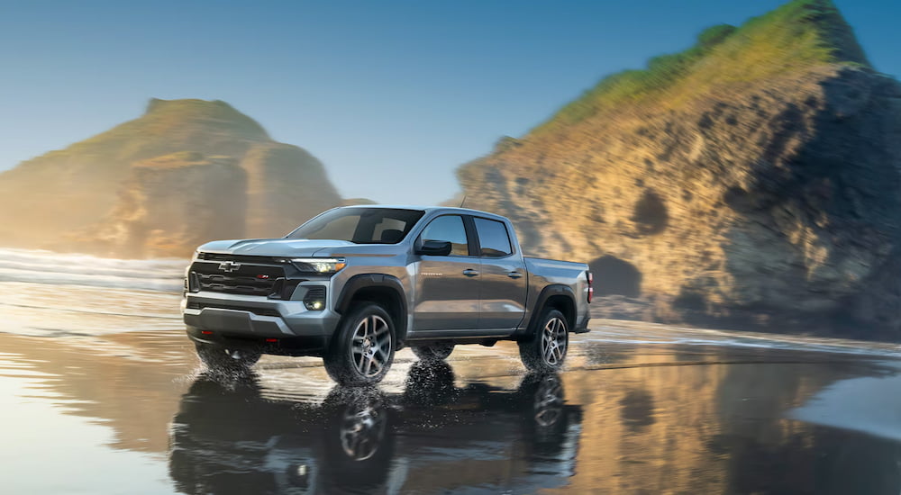 Grey 2025 Chevy Colorado Z71 for sale driving over wet sand.