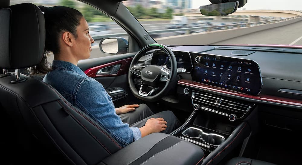 A person driving in a 2026 Chevy Traverse.