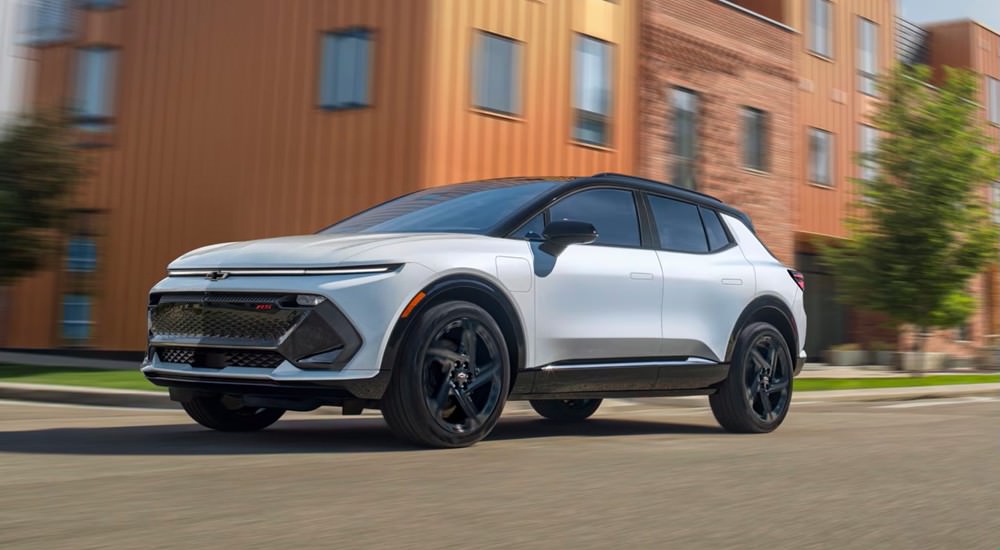 White 2026 Chevy Equinox EV driving on a city street