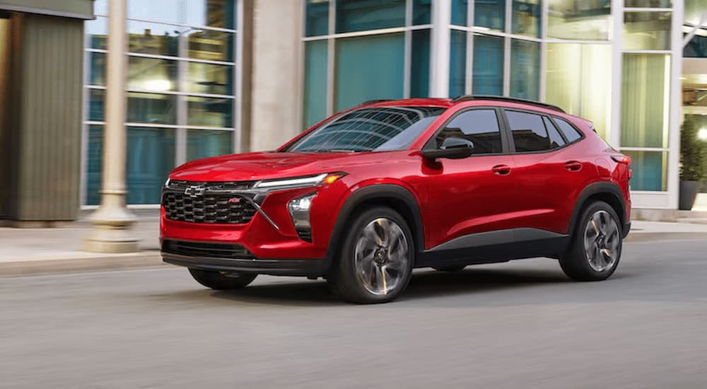Red 2026 Chevy Trax RS driving on a city street