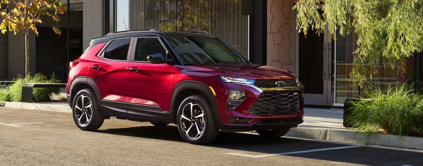 A red 2021 Chevy Trailblazer parked next to a building.