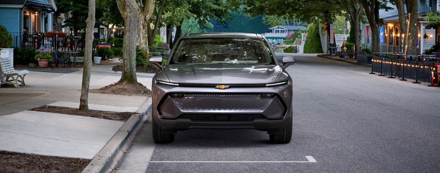 Silver 2024 Chevy Equinox EV 1LT parallel parked in a city