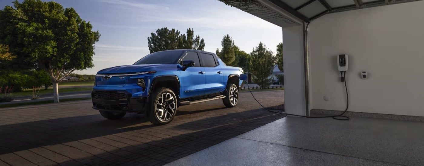 Blue 2024 Chevy Silverado EV RST parked in a driveway