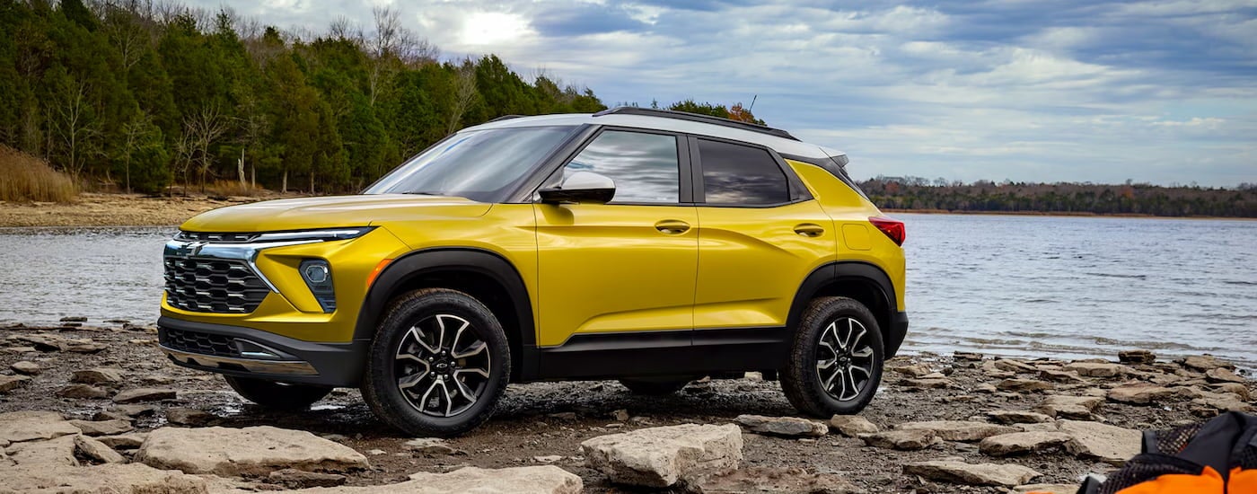 Yellow 2026 Chevy Trailblazer parked by a lake.
