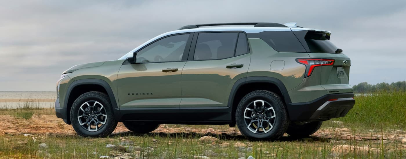 Rear of a green 2026 Chevy Equinox ACTIV parked off-road.