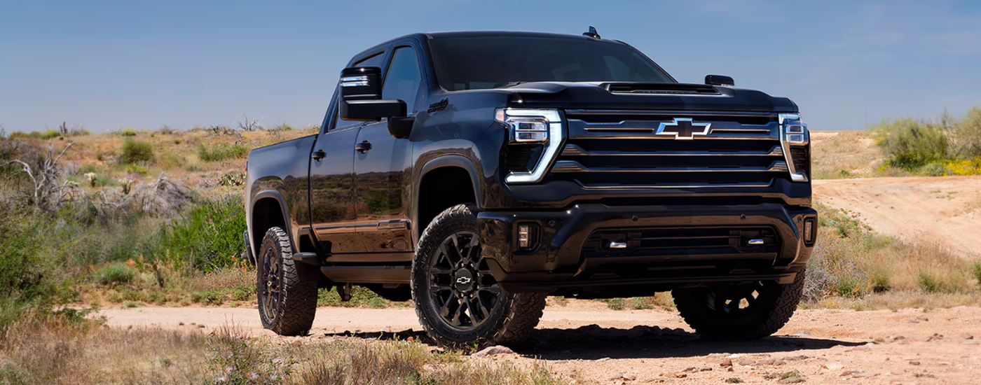 Black 2026 Chevy Silverado 2500 HD parked off-road