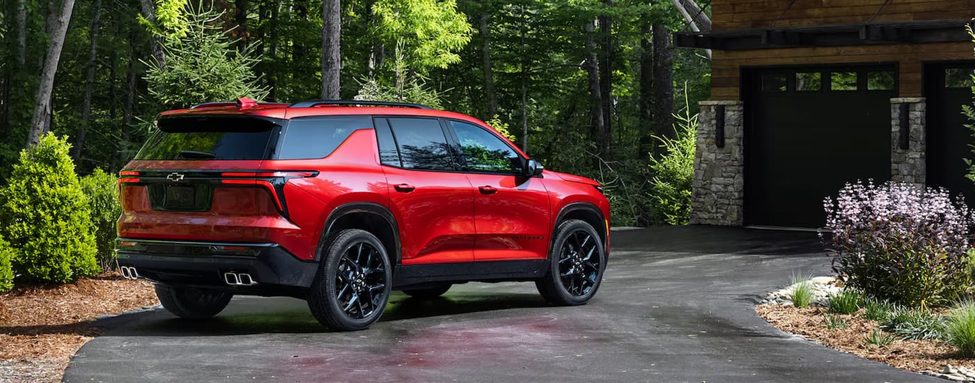 Rear of a red 2026 Chevy Traverse parked on a driveway.