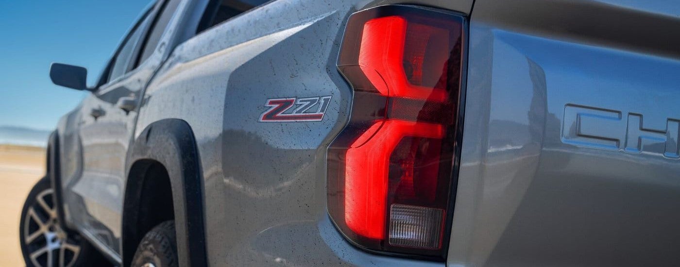 Close-up on the taillight of a grey 2024 Chevy Colorado.