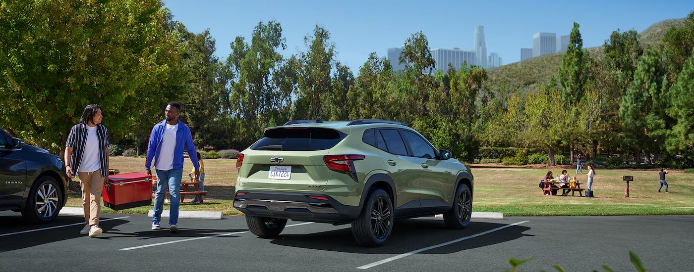 Rear of a green 2025 Chevy Trax ACTIV parked on a parking lot.