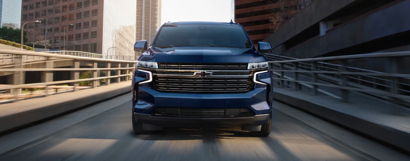 Front of a blue 2023 Chevy Tahoe down a bridge.