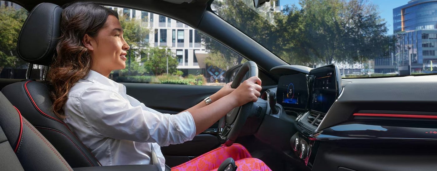 A person driving in a 2026 Chevy Trax for sale.