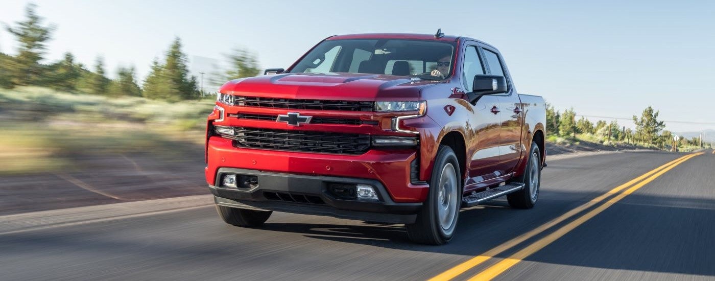 Red 2020 Chevy Silverado 1500 Z71 driving down an open road.