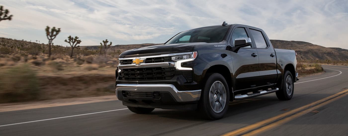 A black 2022 Chevy Silverado 1500 LT is shown from the front at an angle.