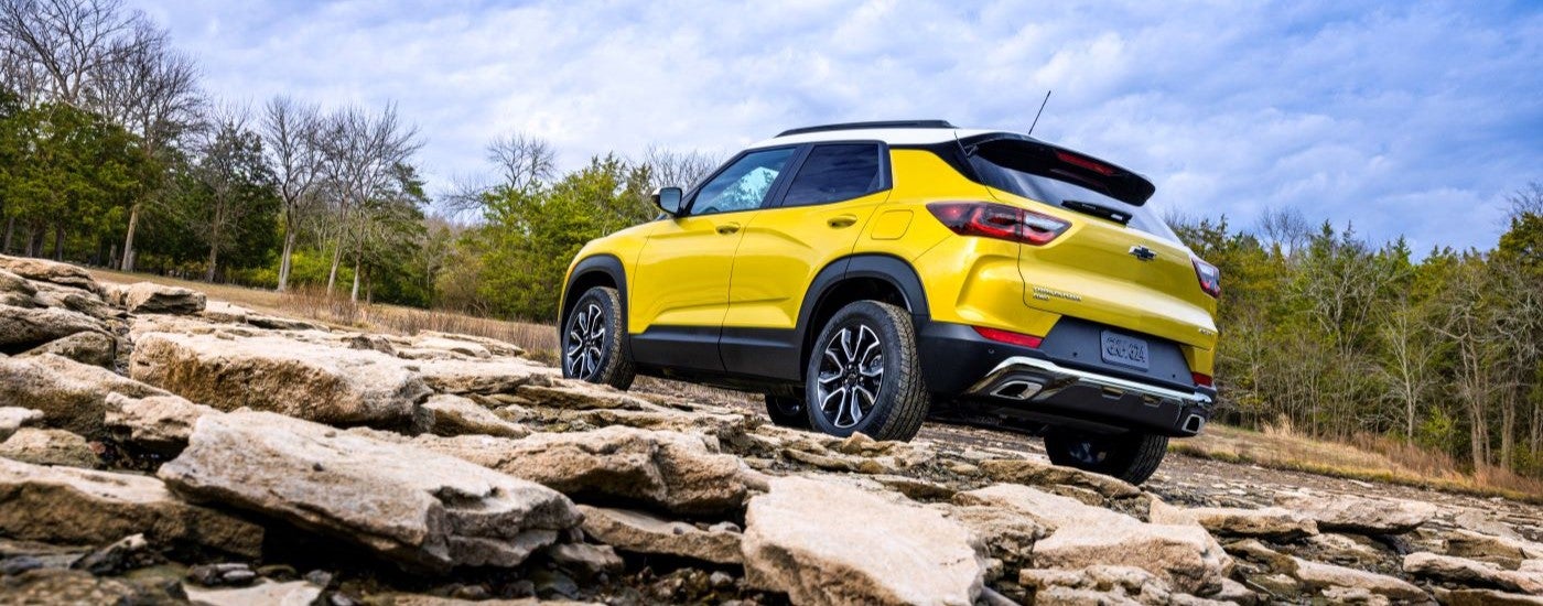 A yellow 2024 Chevy Trailblazer ACTIV parked off-road on rocks